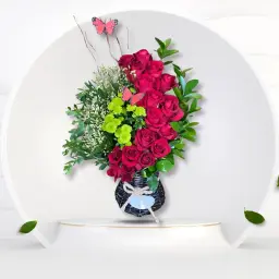 Black Basket Elegantly Decorated With Red Roses Green Plants And Butterflies